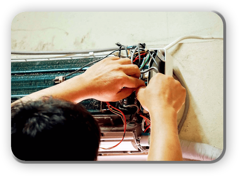 A person working on wires in an electrical box.