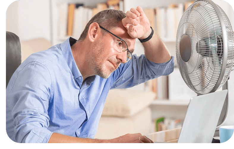 A man sitting at his computer looking bored.