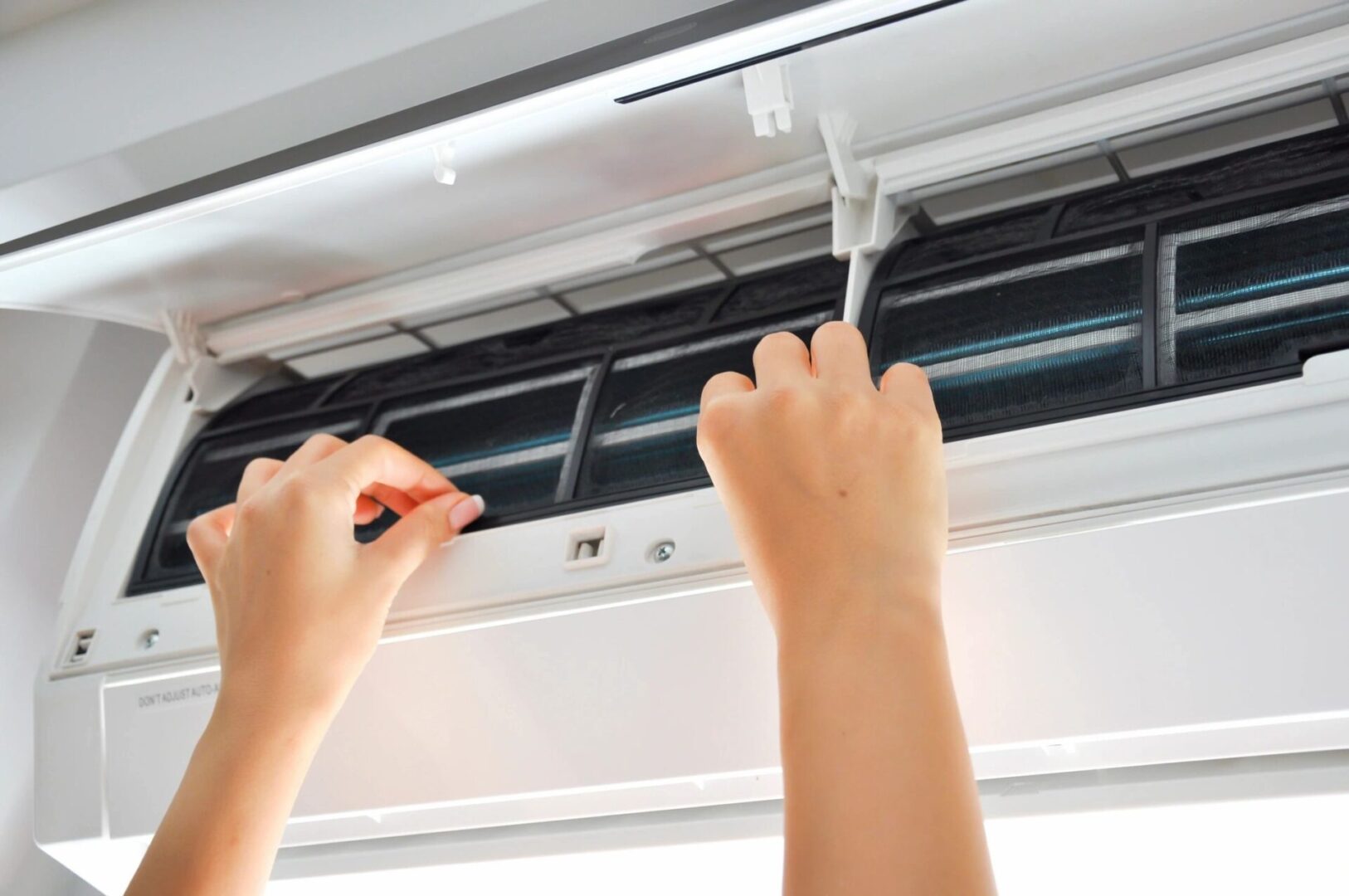 A person is working on an air conditioner.